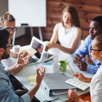 Group of 5 people having a meeting while seated